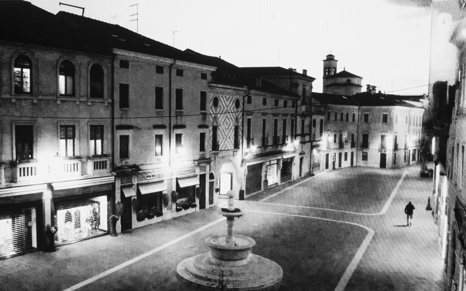 Thiene, Chilesotti Square - A lone figure passed Chilesotti Square of Thiene. Prevence Vicenza. March 25. 2020.